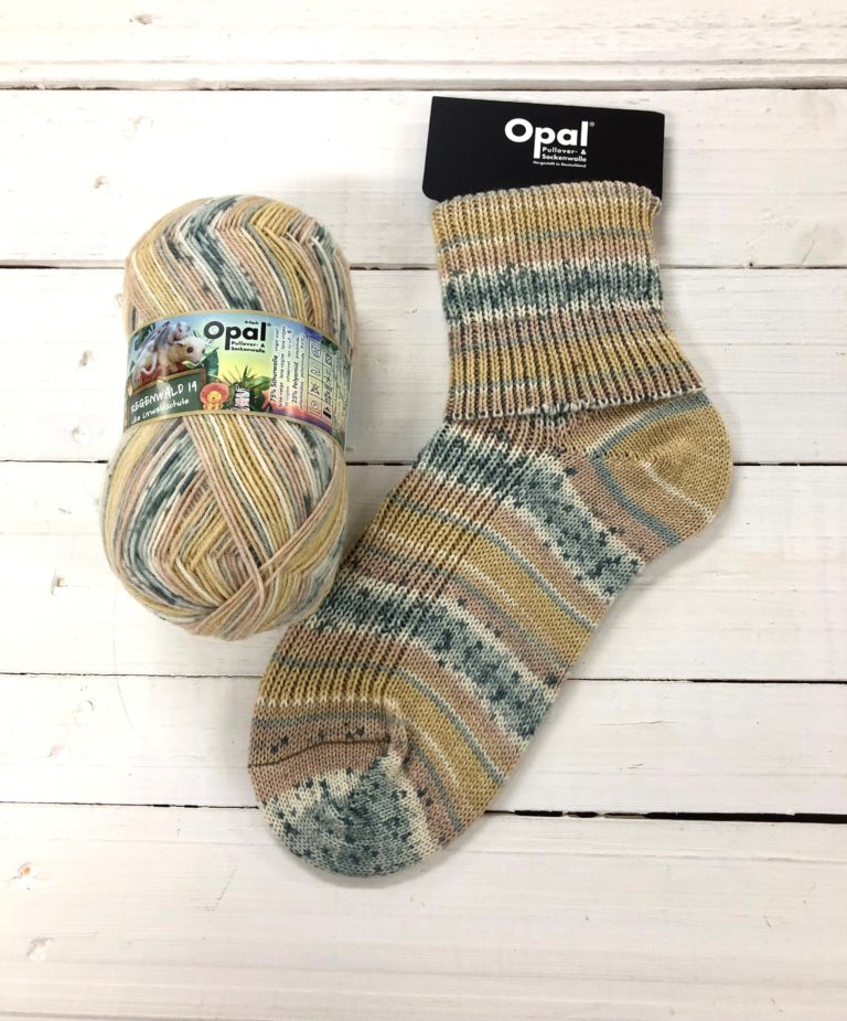 11332 - Beige, pale yellow, grey and cream self striping sock with a black speckle on the grey and cream sections