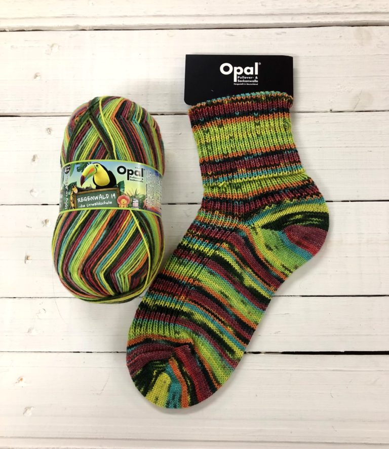 11334 - Lime green, orange, black, red and pale blue self striping sock with a light black speckle