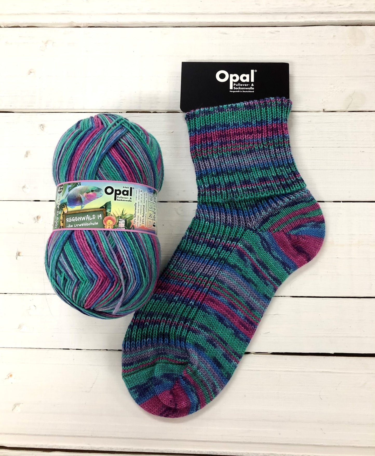 11335 - Teal, blue, fuchsia and lilac self-striping sock with black speckle.
