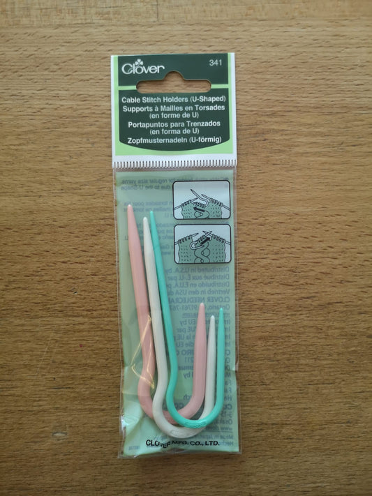 U-shaped stitch holder in 3 different sizes. Pink is large, white is medium and green is small.
